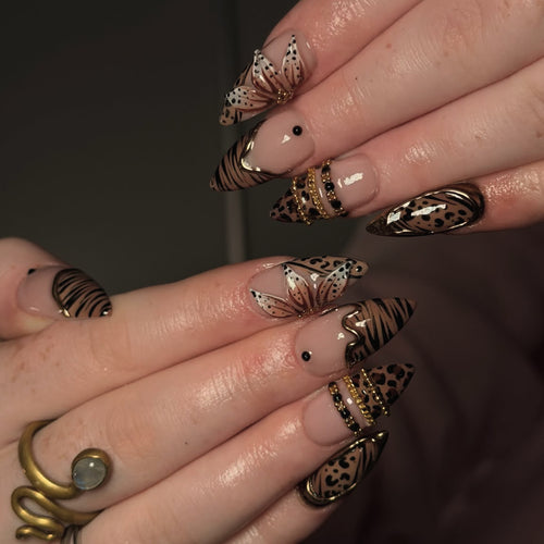 Artful stiletto nail with floral accents and gold embellishments Bowlift