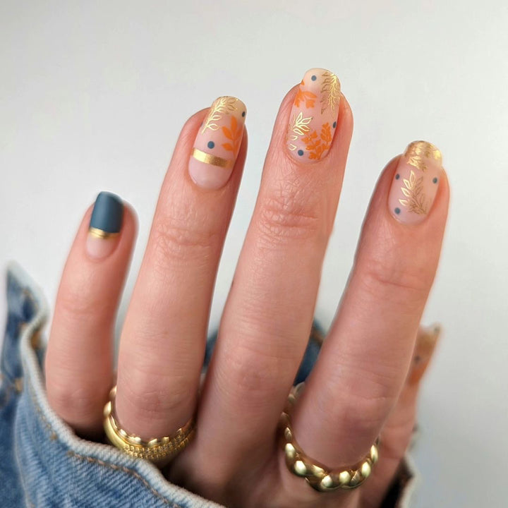 Artistic nail design with floral and golden accent Bowlift