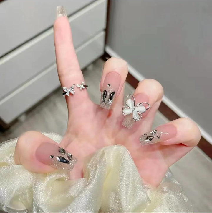 Artful Nail Art with Glitter and Butterfly Elements Bowlift
