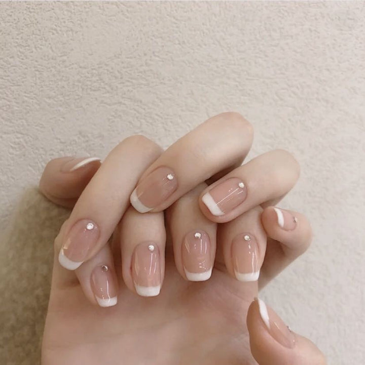 Artificial nails with elegant French tip and rhinestone accents Bowlift