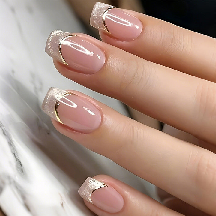 Artificial nail creations with elegant gold trim Bowlift