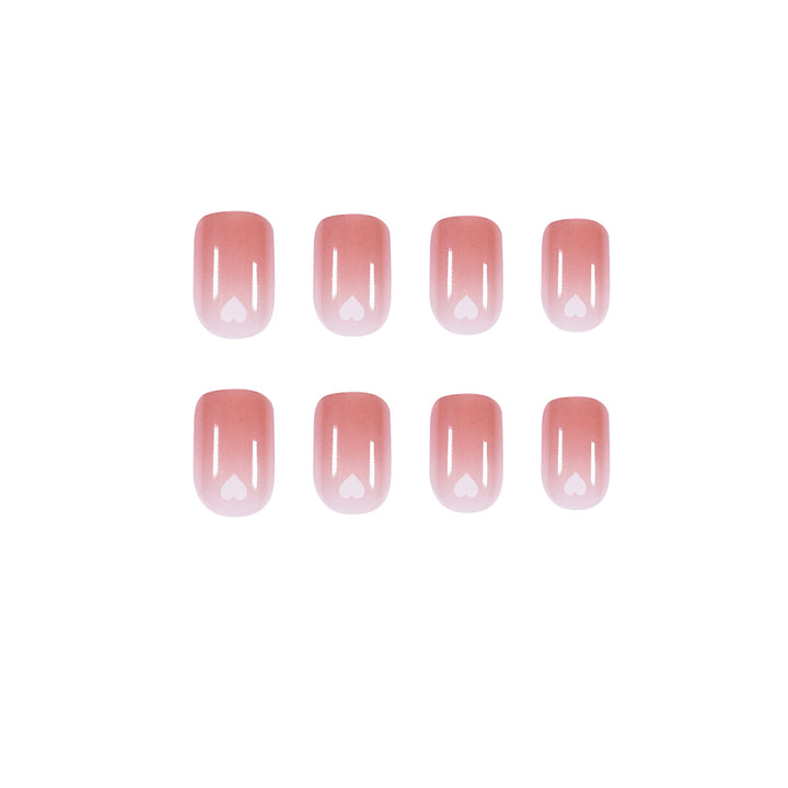 Artful nail art with heart-shaped accents and gentle ombre effect Bowlift