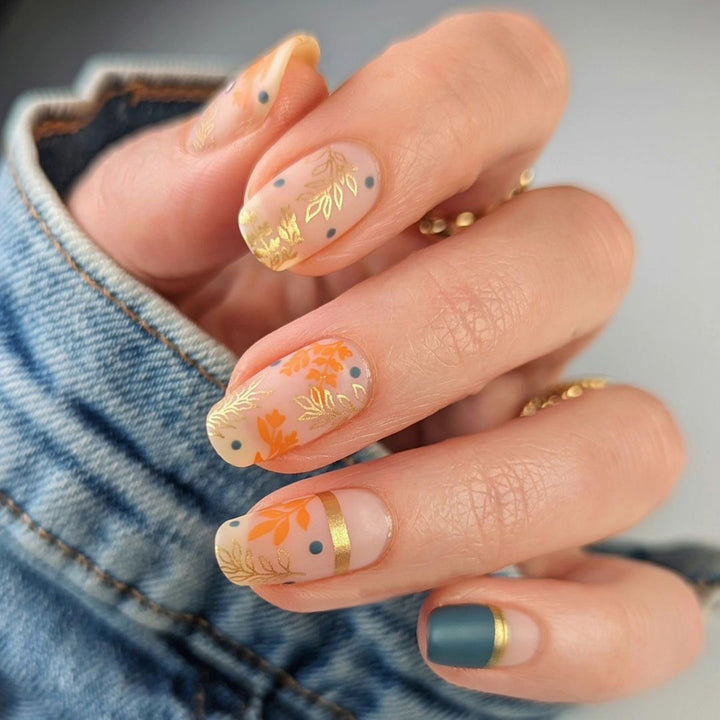 Artistic nail design with floral and golden accent Bowlift