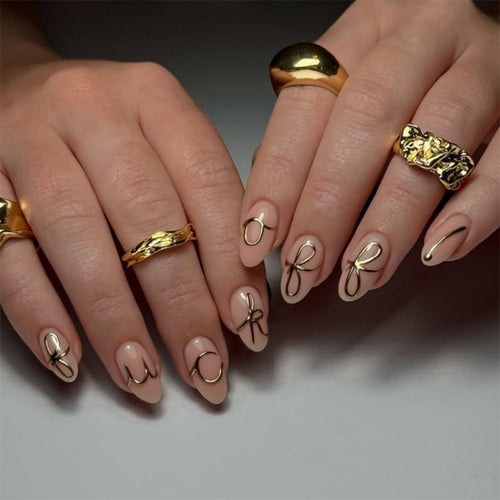 Creative nail art with golden accents and trendy lettering Bowlift