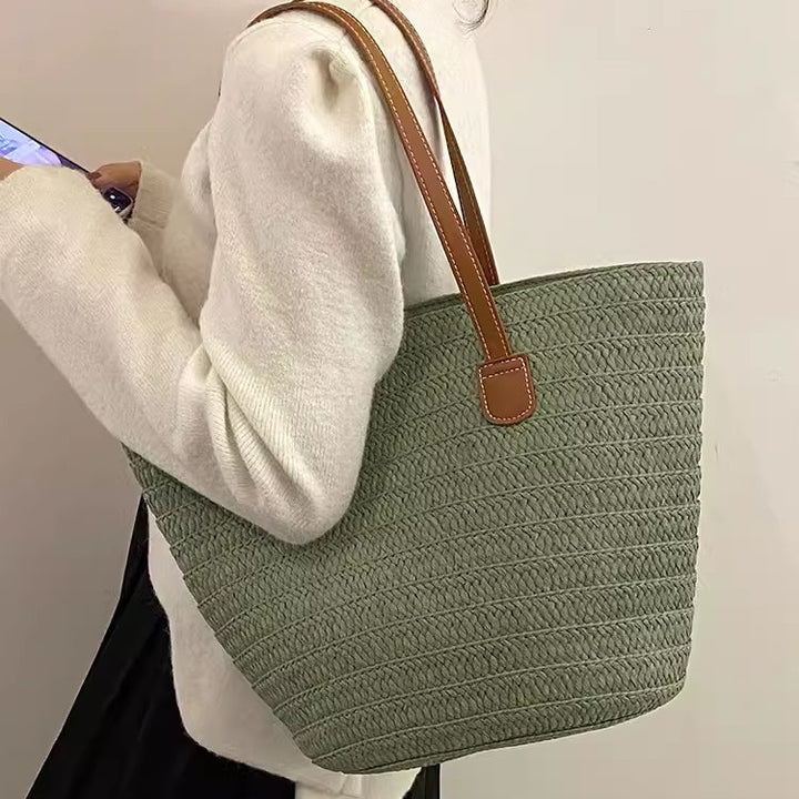 Stylish beach bag made of woven natural material with leather handles Bowlift