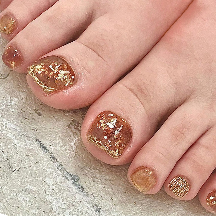 Artful toenail decoration with elegant gold accent Bowlift