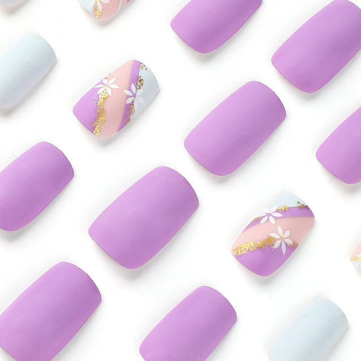 Artistic nail designs with floral motifs and glitter accents Bowlift