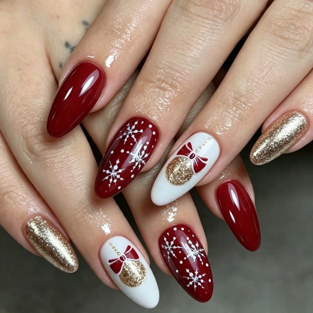 Glamorous artificial nails in festive Christmas design Bowlift