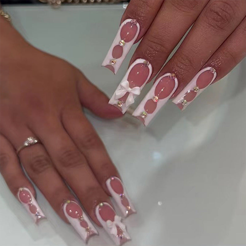Elegant and artistic nail art with rhinestone details Bowlift