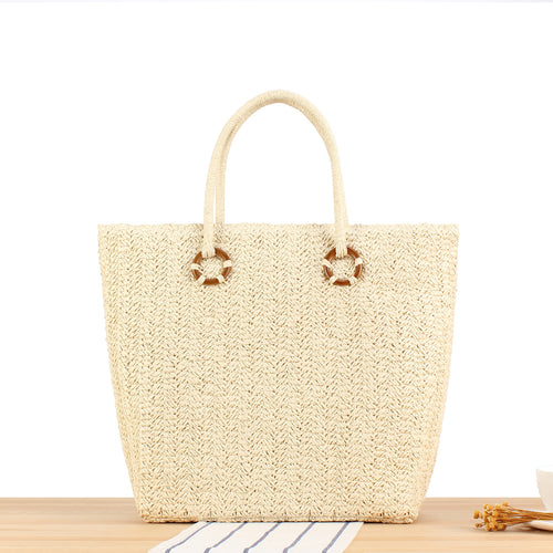 Beach bag made of natural woven material with sturdy carry handles Bowlift