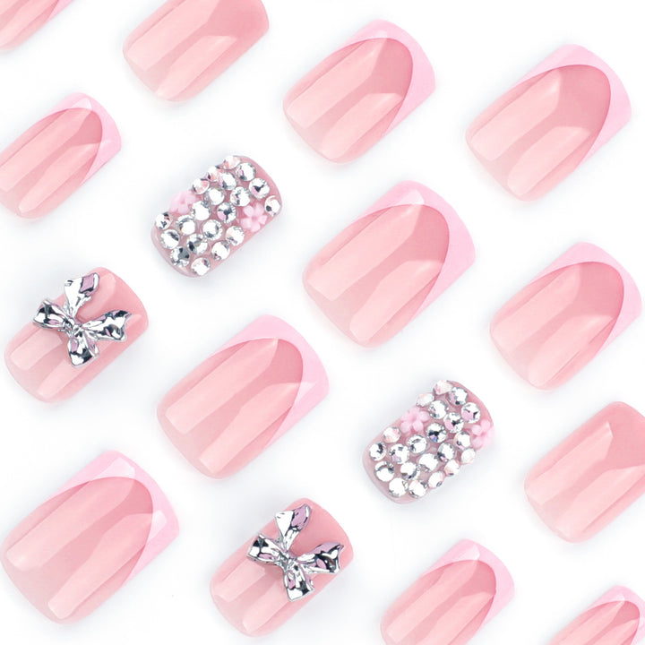 Artful nail art with glitter accents and bow decoration Bowlift