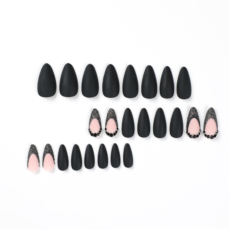 Artful stiletto nails with elegant black design and glitter accents Bowlift