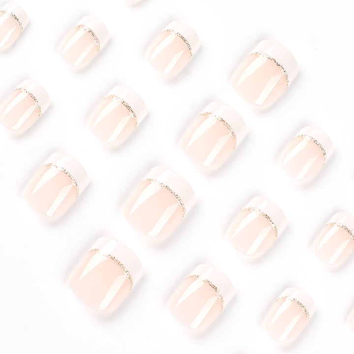 Artful nail extensions with elegant French tip and gold accents Bowlift
