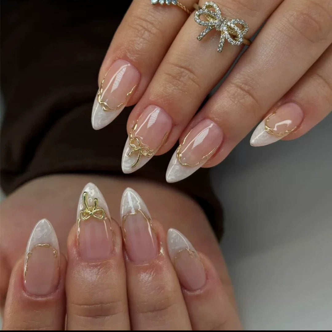 Artificial nails with elegant tip decorations and golden accents Bowlift