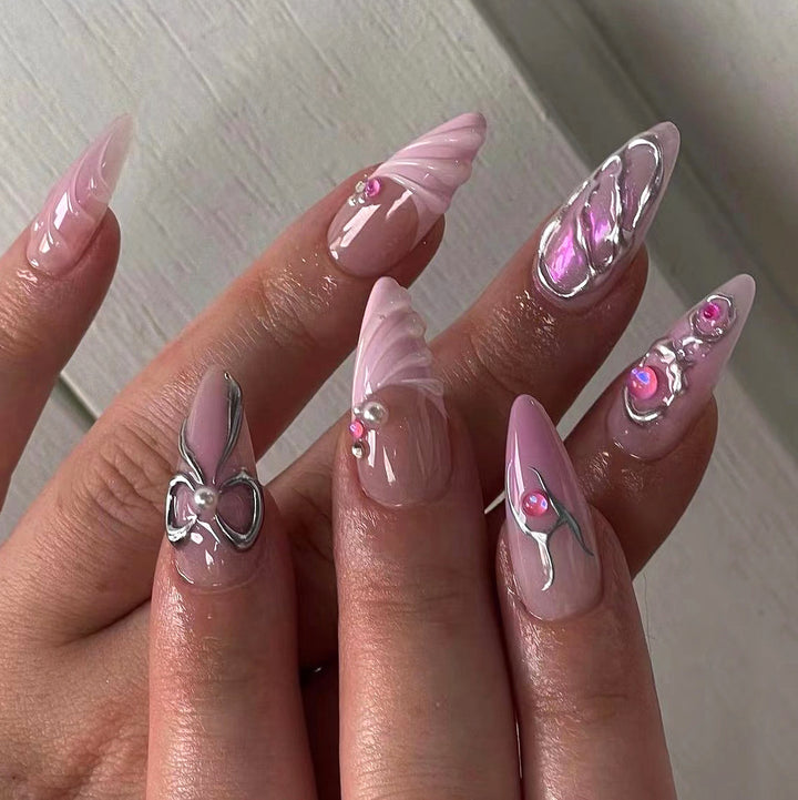 Artful stiletto nails with glitter and pearl decorations Bowlift