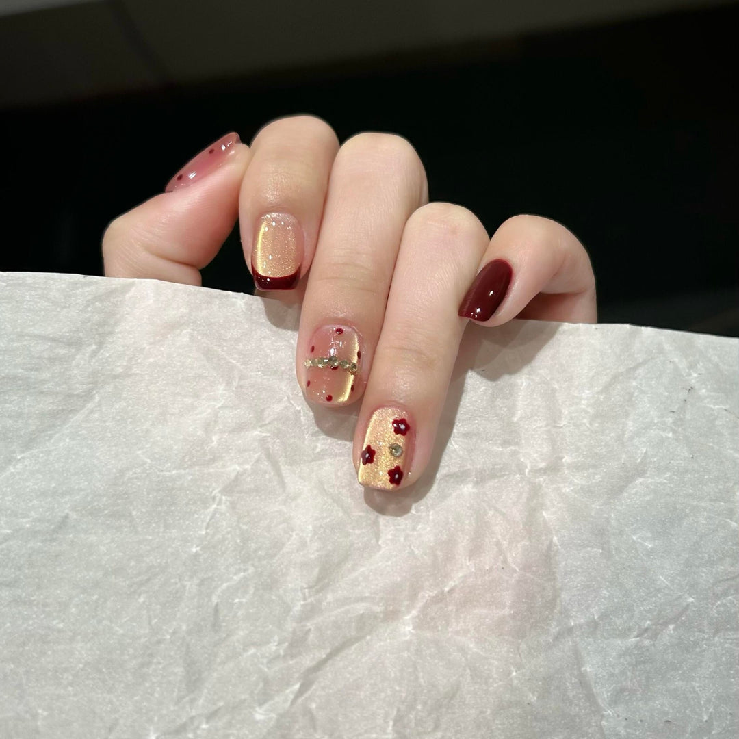Artificial nails in luxurious glamour design with floral and glittering accents Bowlift
