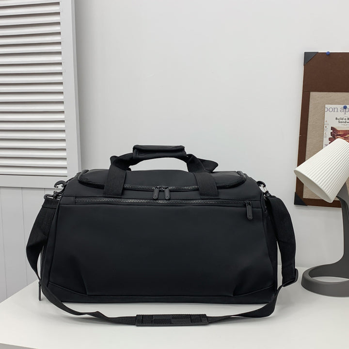Sporty travel bag with reinforced carrying handles and multiple compartments Bowlift