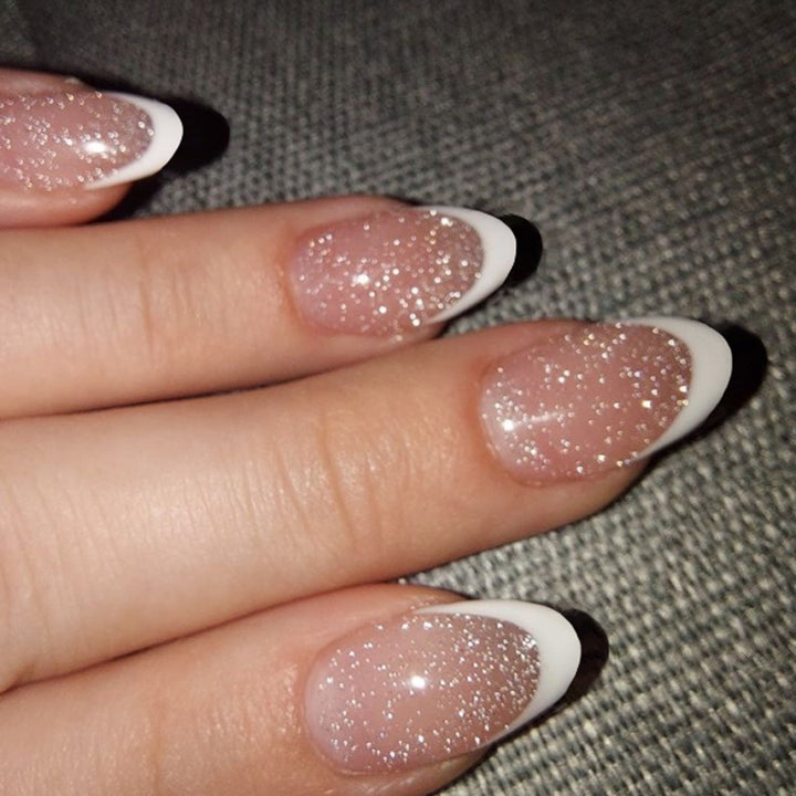 Artful nail art with glitter in gentle tones and elegant tips Bowlift