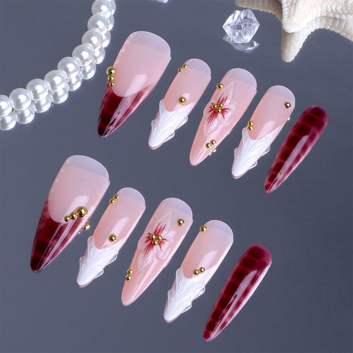 Artificial Nails in Elegant Modern Stiletto Style with Floral Design and Golden Accents Bowlift