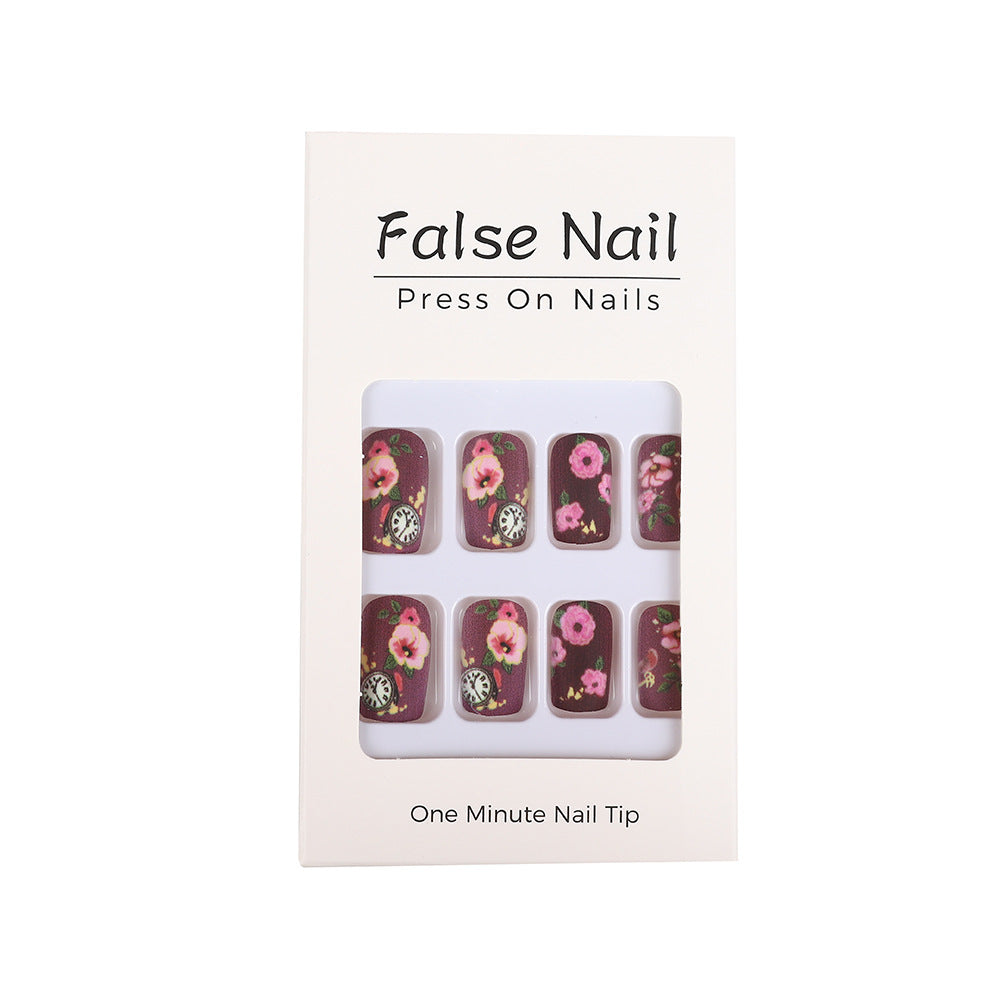 Nail art with floral design and intricate clock motifs Bowlift