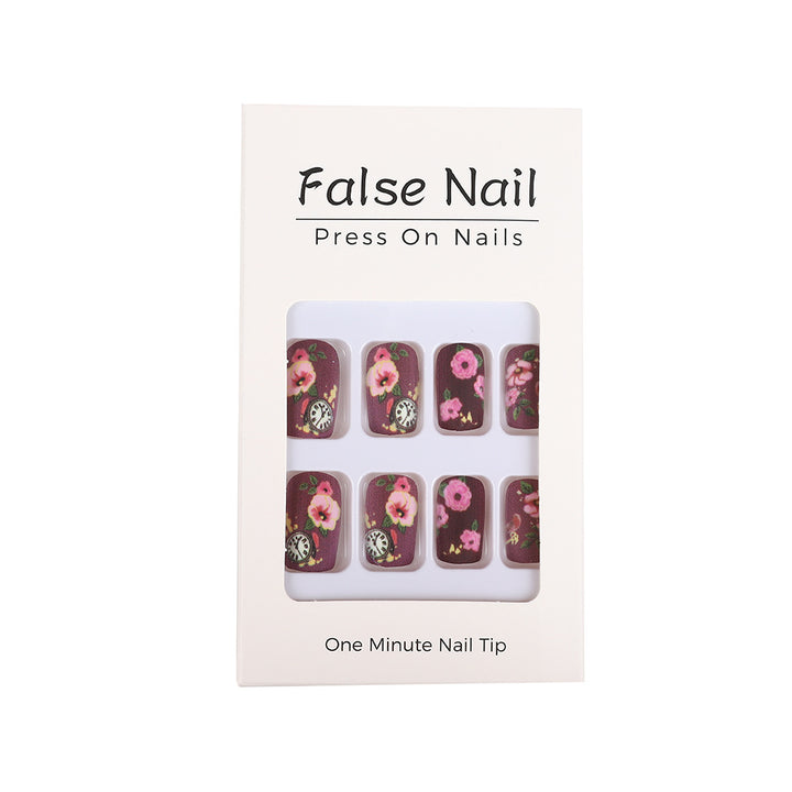 Nail art with floral design and intricate clock motifs Bowlift