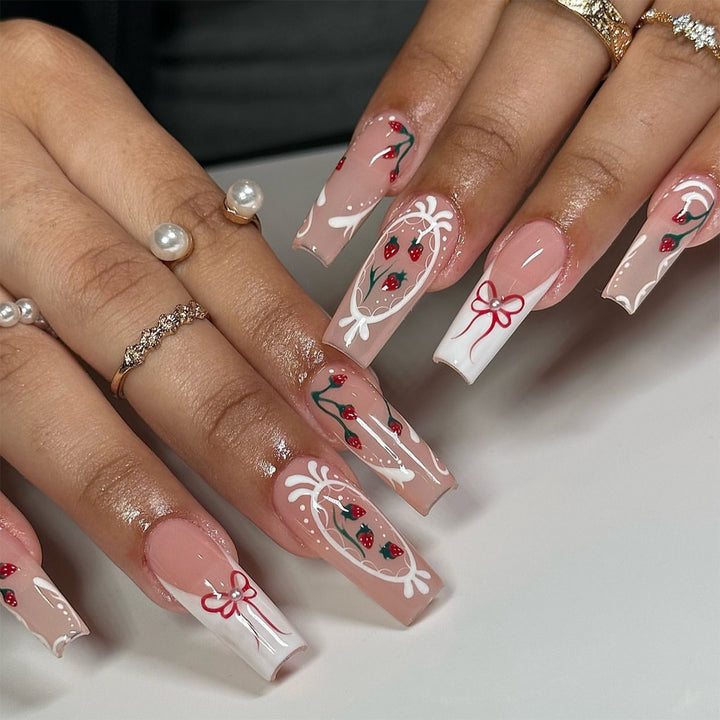 Artful nails with strawberry motifs and bow accents Bowlift