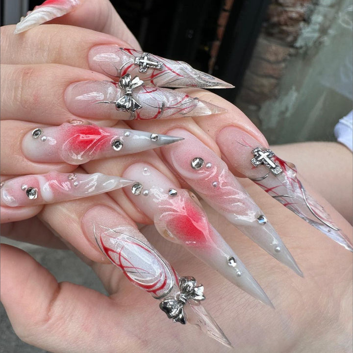 Artful stiletto nails with elegant floral accents and glitter embellishments Bowlift