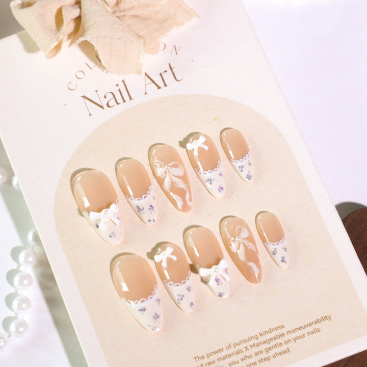 Artful nail art with elegant bows and rhinestone details Bowlift