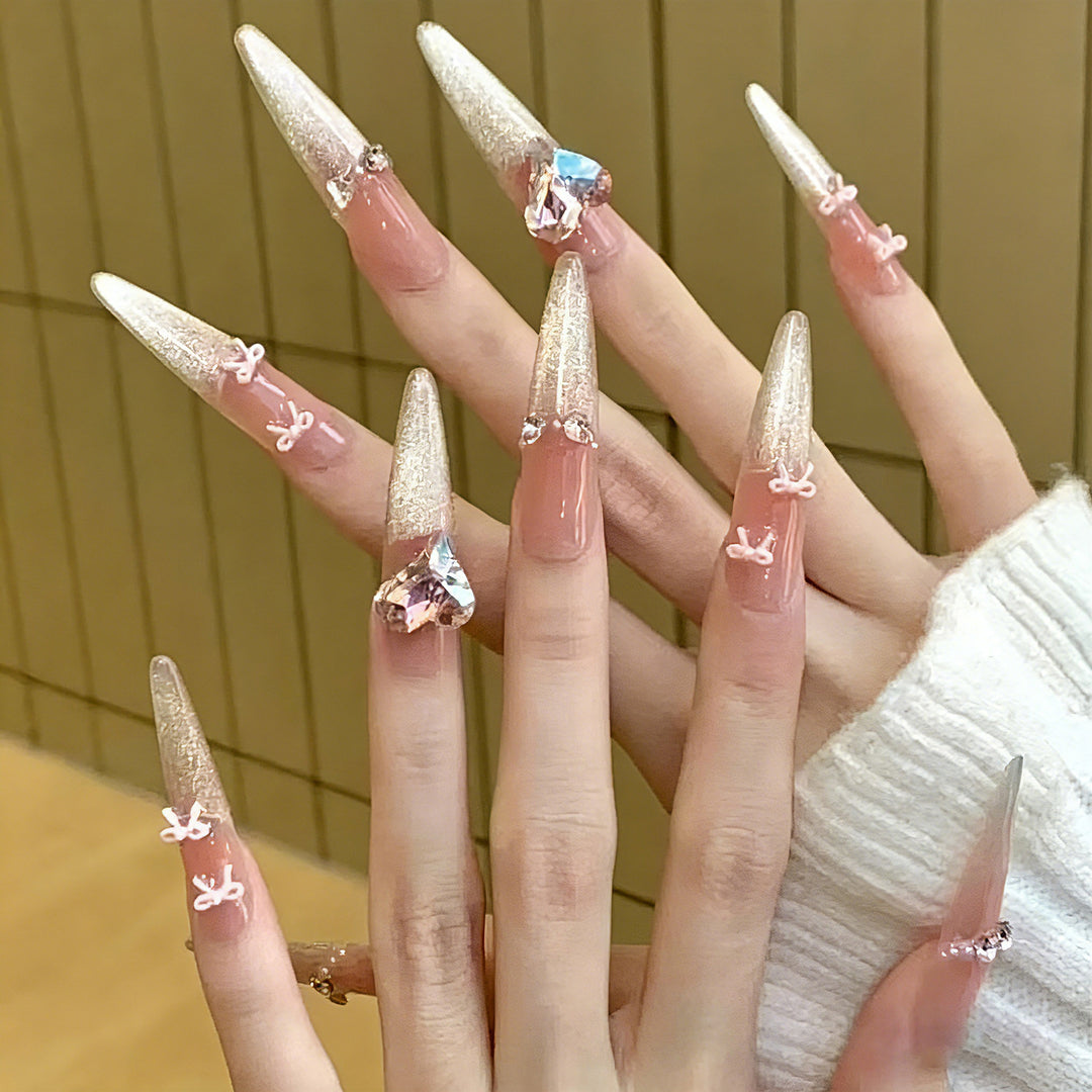 Art nail set with sparkling tips and delicate bow decorations Bowlift