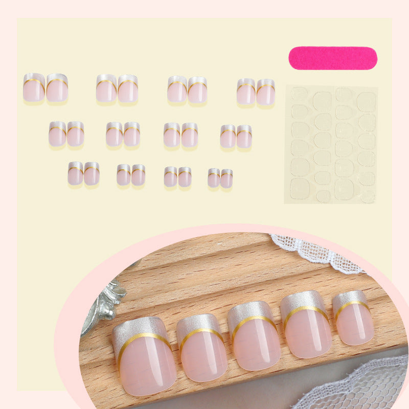 Artificial nail creations with elegant gold trim Bowlift