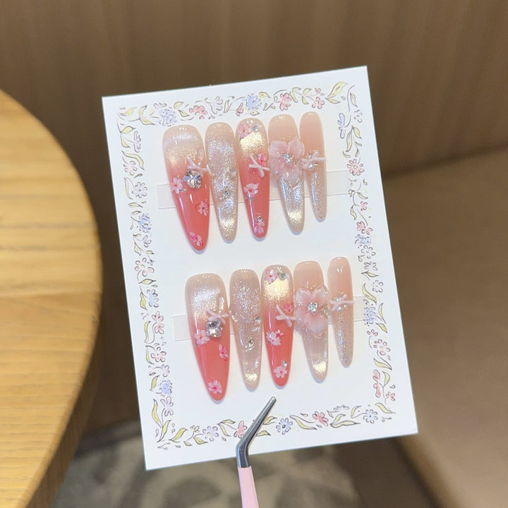 Artificial nails with floral embellishments and glitter effects Bowlift