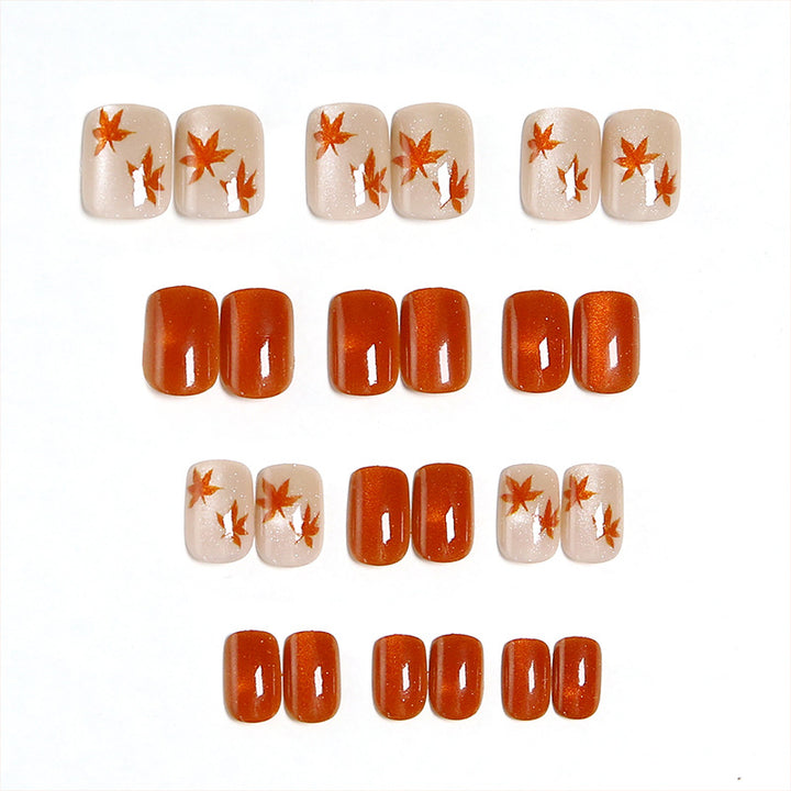 Artificial nails with glamorous ombre design and autumn leaf applications Bowlift