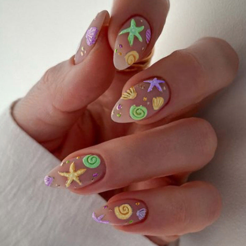 Artistic Press-On Nail Design with Ocean-Inspired Accents Bowlift