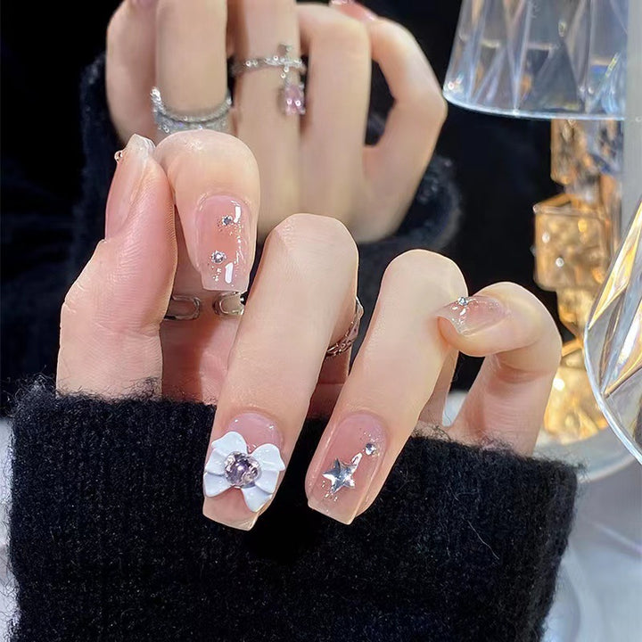 Artistic nail tips with floral and glittering accents Bowlift