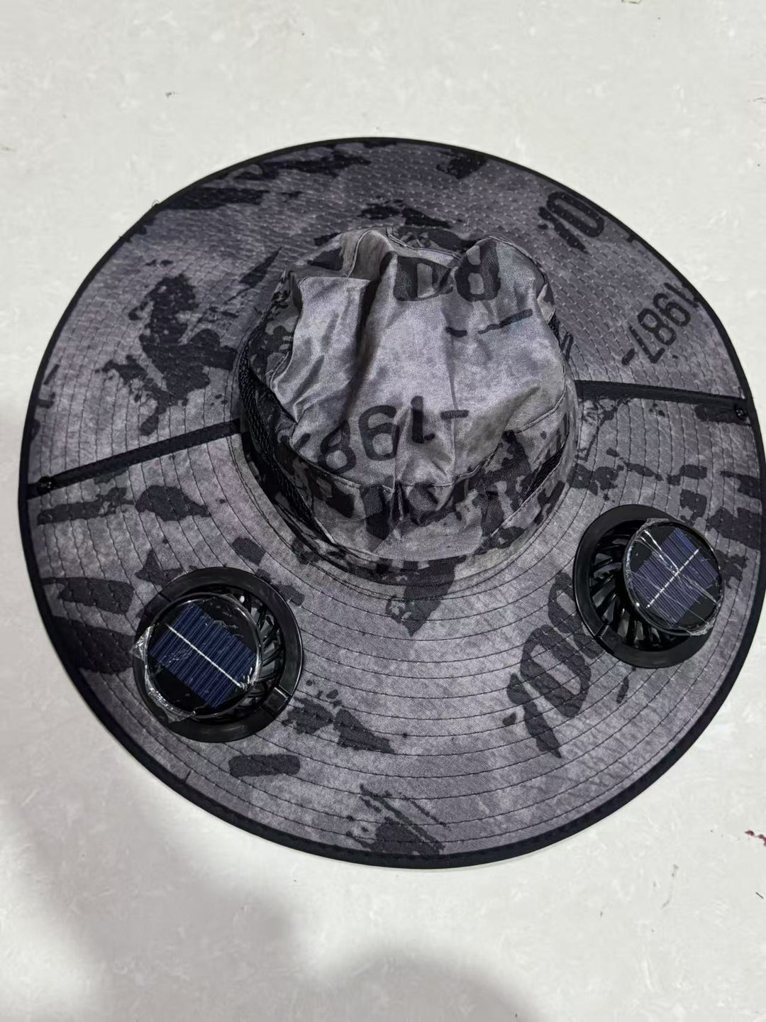 Ventilated sun hat with integrated battery fans, breathable mesh inserts, and adjustable chin strap Bowlift