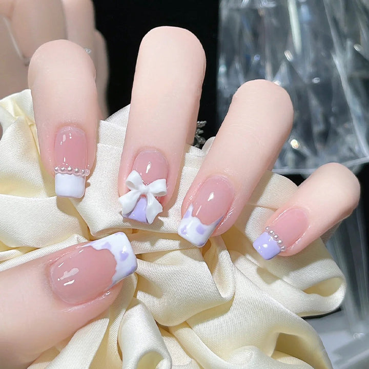Nail art set with elegant wave patterns and delicate pearl accents Bowlift