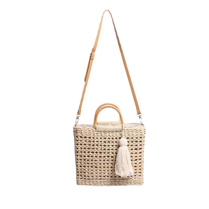 Handcrafted straw shoulder bag with decorative tassel pendant Bowlift