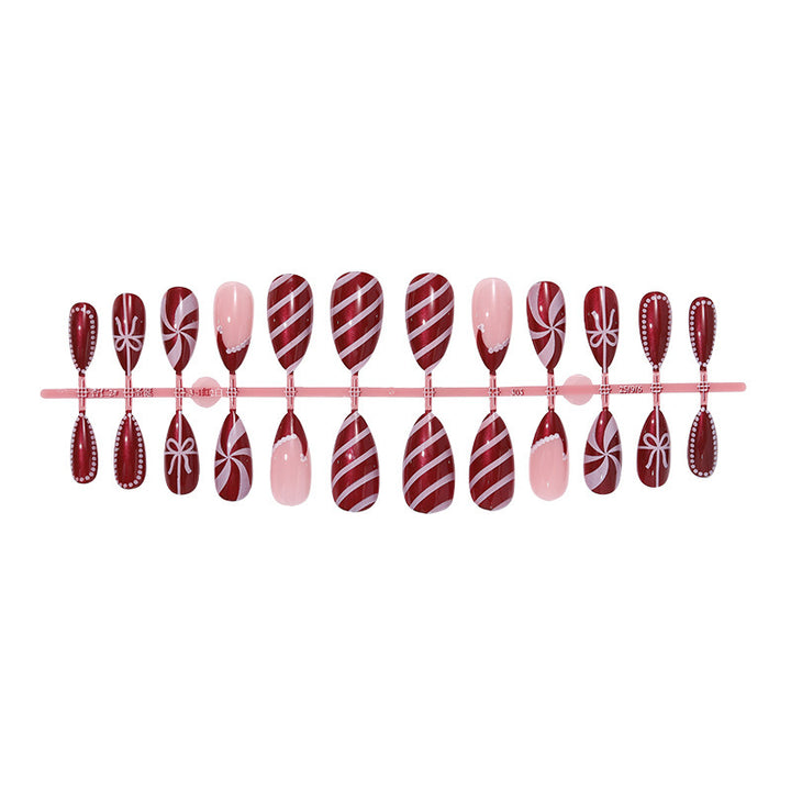 artfully designed nail set with festive candy cane motifs Bowlift
