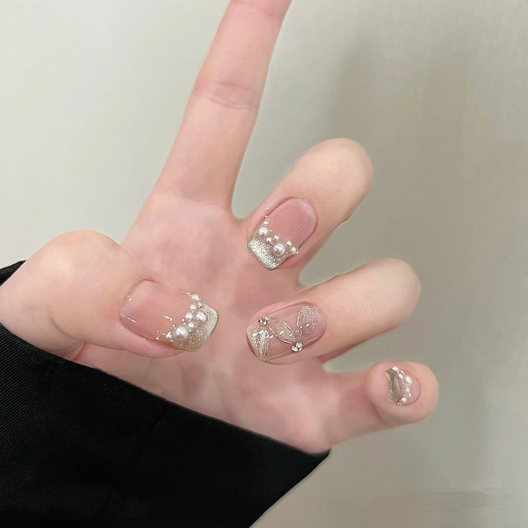 Elegant artificial nails with pearl decorations and glitter effects Bowlift