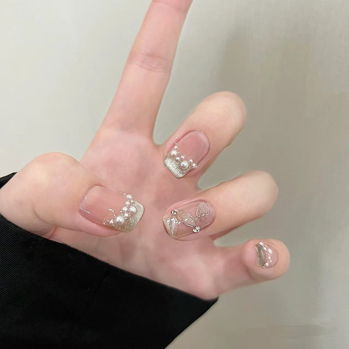 Elegant artificial nails with pearl decorations and glitter effects Bowlift