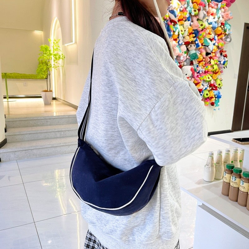 Fashionable shoulder bag with unique cut and adjustable strap Bowlift