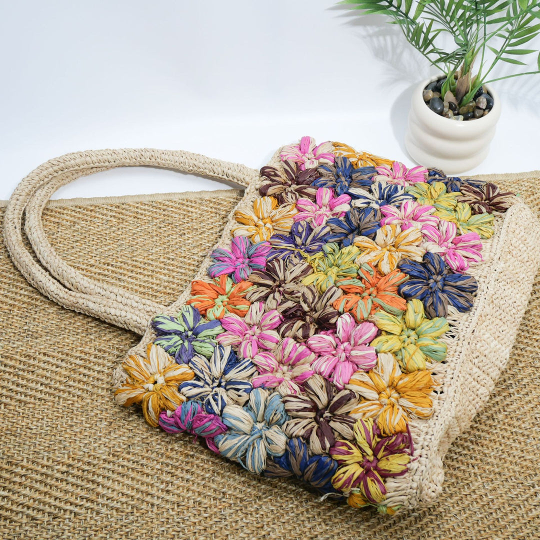 Handcrafted straw bag with floral appliqués Bowlift