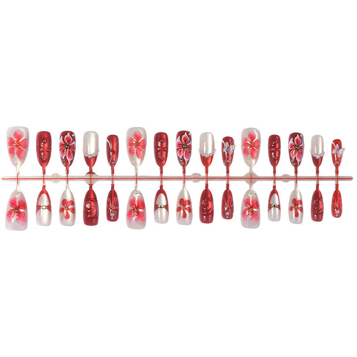 Artificial nail set with floral designs and glamorous accents Bowlift