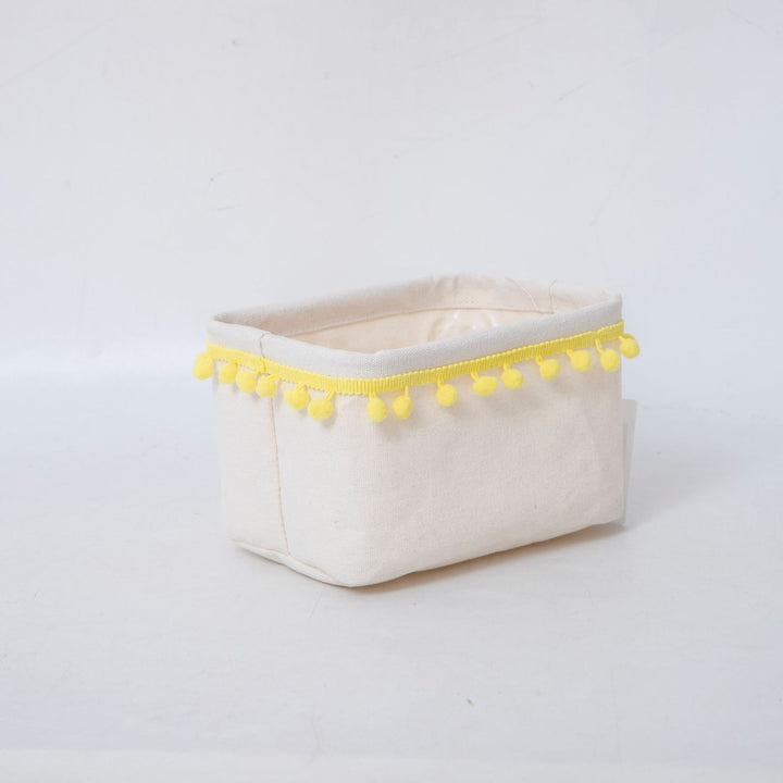 Storage basket with decorative pom-pom trim