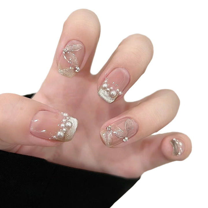 Elegant artificial nails with pearl decorations and glitter effects Bowlift