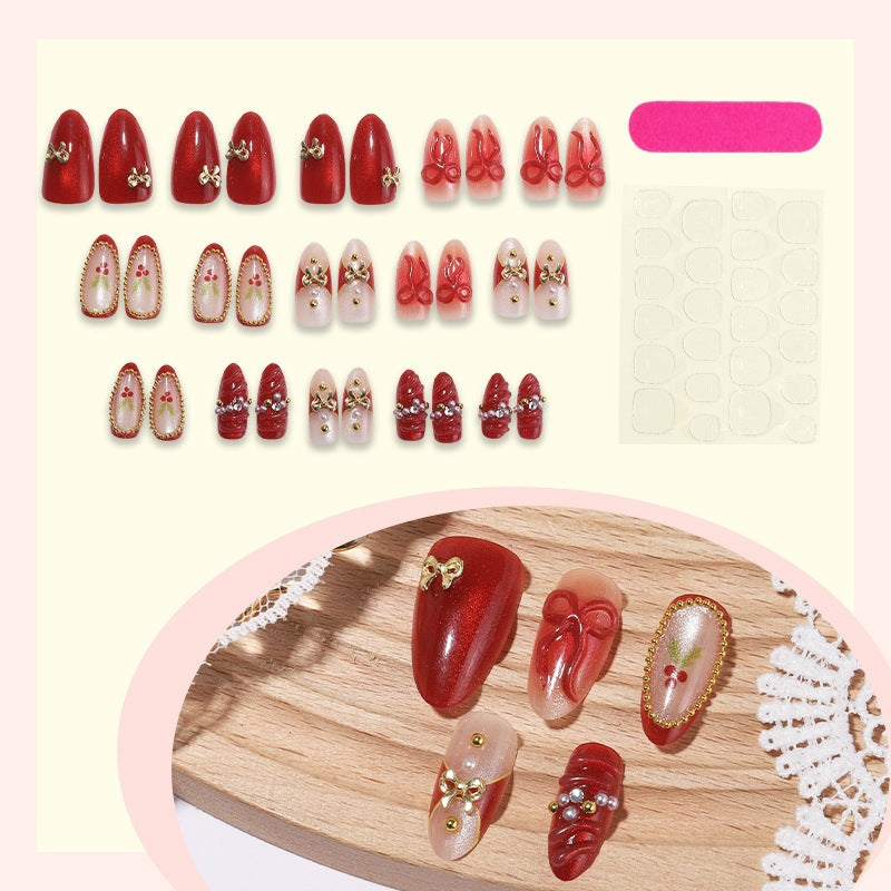 Artificial nail set with glamorous decorations and festive accents Bowlift