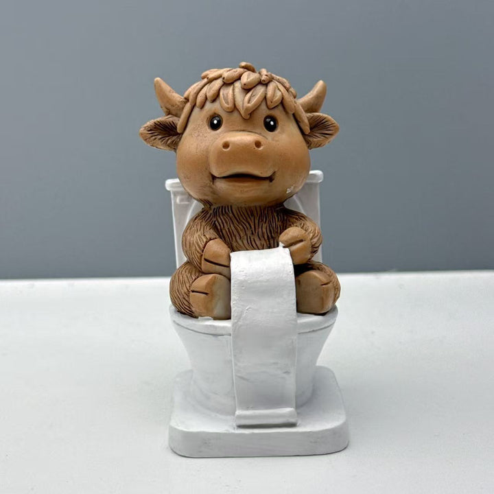 Funny decorative figure of a Highland cow on toilet Bowlift