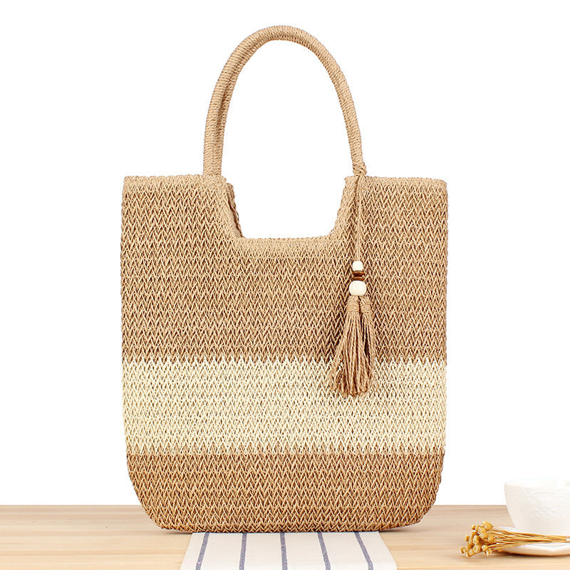 Fashionable beach tote bag made of woven natural material with fringed detail Bowlift