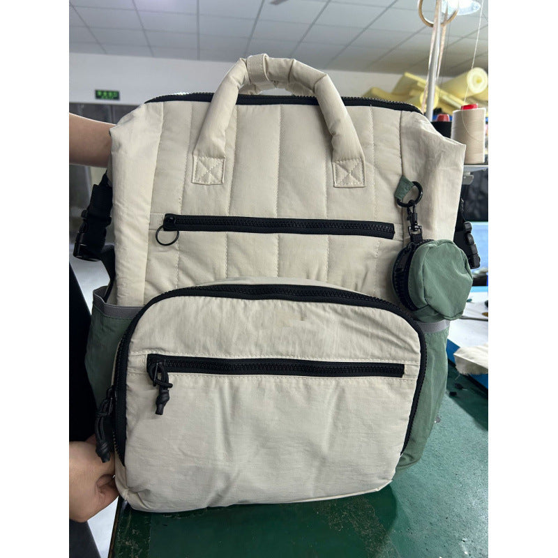 Multifunctional backpack with padded carrying handles and multiple compartments Bowlift