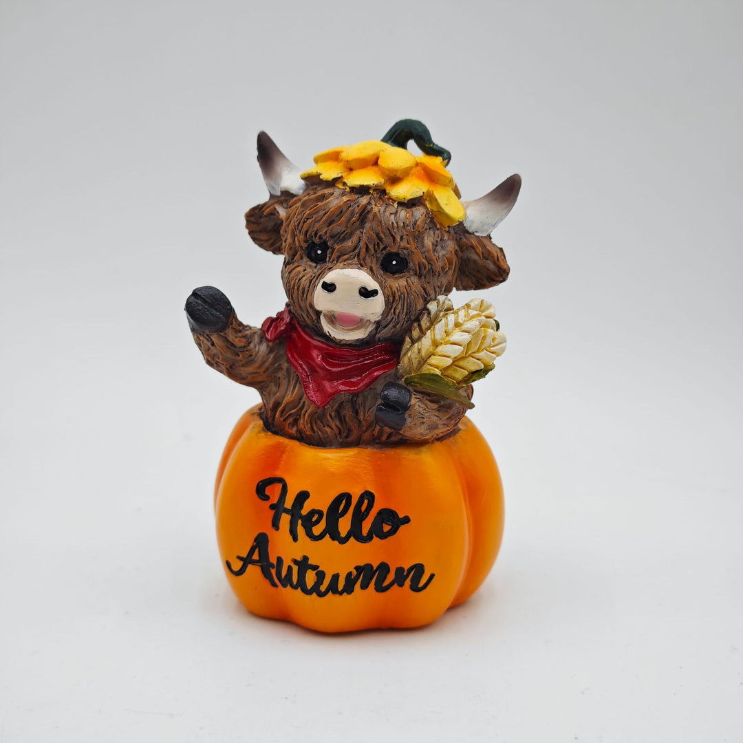 Funny decorative figure of a Highland cow in pumpkin costume Bowlift